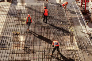 overhead of men working on concrete roadway